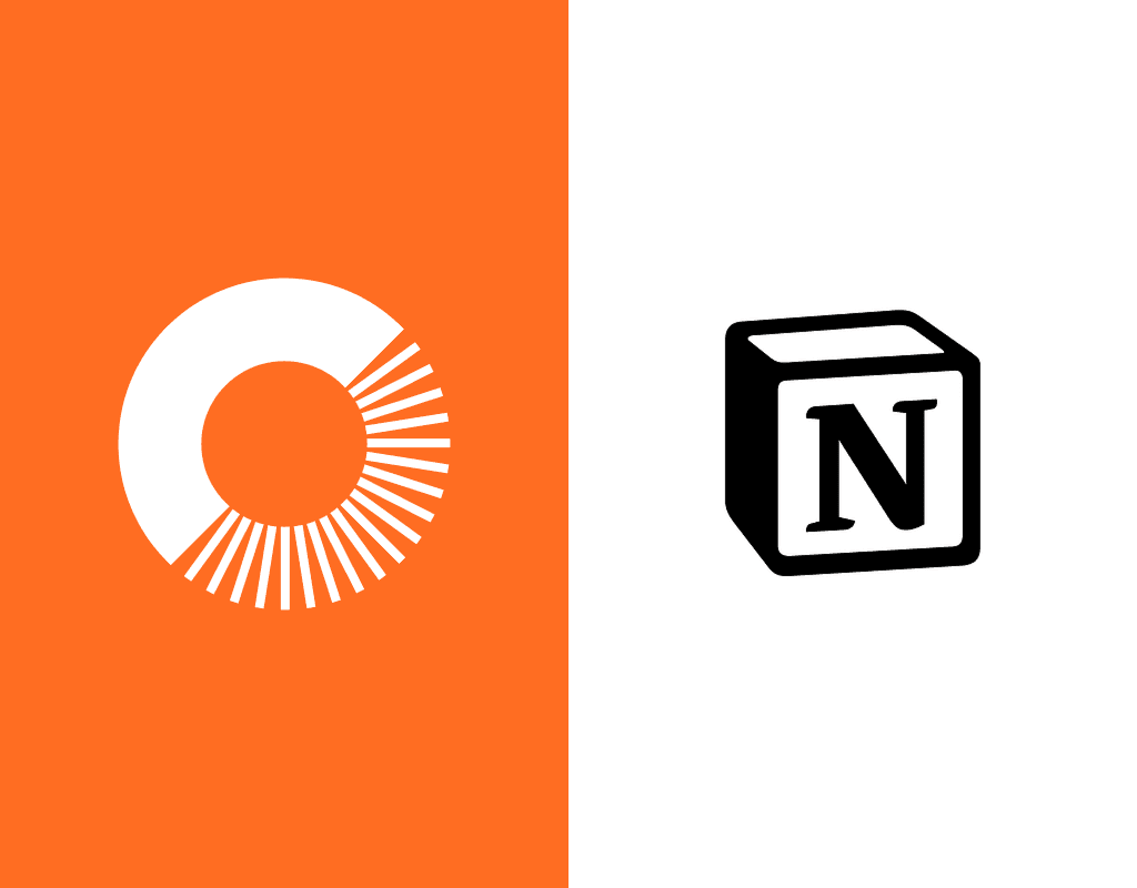 A cluttered desk with notebooks, sticky notes, and an open laptop, representing an overwhelming system.